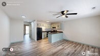 Located at 616 E Knox St in Durham, NC, this one-bedroom, one-bathroom residence offers a well-designed layout that maximizes every inch of its compact footprint. The open-concept main living area seamlessly connects the living room, dining space, and kitchen, creating an airy and functional hub for daily living. Light-toned, hardwood-style flooring runs throughout the entire unit, lending a cohesive and modern feel, while ceiling fans in the main living area provide added comfort.

The kitchen is a standout feature, boasting a peninsula with dark granite-style countertops that provide ample prep space and double as a casual dining bar. Sage-green cabinetry, black appliances including a full-size refrigerator and electric range, and a deep sink complete the well-equipped cooking space.

The bedroom is a comfortable retreat featuring a ceiling fan, two closets, and sliding glass doors that open to a private balcony with outdoor views — a rare and inviting touch. The full bathroom includes a tub-shower combination and a vanity with coordinating cabinetry. A dedicated laundry area adds everyday convenience, rounding out this practical and stylish Durham residence.