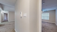 Located in Houston's Westside at 3325 Woodland Park Dr, this single-story residence offers three bedrooms and three bathrooms within a thoughtfully arranged floor plan. Neutral tones, clean white baseboards, and a consistent design palette create a cohesive aesthetic throughout.

The living room stands out with vaulted ceilings and a ceiling fan, lending an open, airy feel. Large vertical blinds cover a sliding door, allowing natural light to filter in. Adjacent to the living area, a dining space features wood-look vinyl flooring and a pendant light fixture.

The kitchen is well-appointed with light gray shaker cabinetry, white quartz countertops, a subway-style tile backsplash, and a full suite of stainless steel appliances including a refrigerator, range, microwave, and dishwasher. Wood-look vinyl flooring and overhead lighting complete the space.

Each bedroom features plush carpeting and ceiling fans. The primary bedroom includes access to a walk-in closet with built-in wire shelving. The bathrooms are finished with light wood-tone vanities, white quartz countertops, large-format tile tub surrounds, and wood-look vinyl flooring. A security panel is conveniently located near the main hallway entrance.
