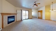 Located at 1405 N McCarthy Rd in Appleton, Wisconsin, this two-bedroom, one-bathroom home offers a well-designed single-floor layout with a comfortable and functional living experience. The open-concept main living area seamlessly connects the kitchen, dining, and living spaces, creating a bright and inviting atmosphere. The kitchen features warm oak cabinetry, tile flooring, a peninsula with a breakfast bar, and white appliances including a range, dishwasher, and refrigerator. The living room is generously sized, finished with plush carpeting, a ceiling fan, and a tiled fireplace with a wood mantle as a central focal point. Sliding glass doors lead directly to a private balcony, bringing in natural light and outdoor views. Both bedrooms are carpeted and include natural light from windows and baseboard heating, with the primary bedroom featuring a ceiling fan. The full bathroom includes a wood-toned vanity, tile flooring, and a tub-shower combination. A second half-bath provides added convenience. The home also includes in-unit laundry and five closets throughout, offering exceptional storage. Warm neutral tones and wood accents give the space a cohesive, welcoming character throughout.