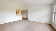 Located at 251 Union Hill Cir in West Carrollton, Ohio, this 2-bedroom, 2-bathroom residence offers a well-organized single-floor layout designed for comfortable everyday living. The entrance opens to a hallway with light hardwood-style flooring that flows through the main living areas. The living room features plush carpet and a pass-through window connecting to the kitchen, creating an open, airy feel. The kitchen is equipped with warm honey-toned wood cabinetry, white appliances including a refrigerator, range, and built-in microwave, and is conveniently positioned adjacent to the dining area. Both bedrooms are carpeted and bathed in natural light through large windows with views of surrounding greenery. The primary bedroom is generously sized and features a wide triple-window bank that fills the room with daylight. The second bedroom also offers a window overlooking the balcony. Four closets throughout the unit provide ample storage, including a spacious walk-in closet with wire shelving. The bathrooms include a full tub and shower combination with clean, white finishes and hardwood-style flooring. A dedicated laundry room adds everyday convenience. A private balcony completes this well-appointed home.