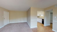 Located at 880 Glendale Dr in Cary, NC, this single-floor residence offers a well-organized layout designed for comfortable everyday living. The main living area is generously sized, featuring warm neutral-toned walls, plush carpeting, and a ceiling fan overhead. Large sliding glass doors flood the space with natural light and provide direct views of the outdoors, while a secondary window further enhances the bright, open atmosphere. The living area transitions smoothly into the kitchen, which is equipped with white cabinetry, granite-style countertops, wood-look flooring, and a suite of appliances including a black electric range, over-the-range microwave, dishwasher, and refrigerator. The bedroom is a comfortable, carpeted room with a window that brings in natural light, offering a quiet and restful retreat. The full bathroom features wood-look flooring, a shower/tub combination, a vanity with storage, and clean, neutral finishes throughout. The textured ceilings and consistent warm wall tones create a cohesive aesthetic across all rooms. The overall layout is practical and efficient, making effective use of the available space on a single level.