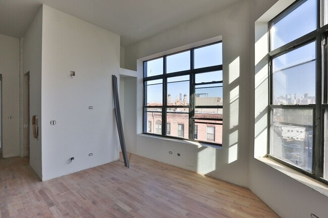 Building Photo - Brand New 1 Bedroom. 12' Ceilings. Huge Windows, Elevator Building. Roof Deck. Free Internet.