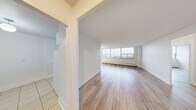 This 670 square foot apartment, located at 185 Shaughnessy Blvd in Toronto, offers a perfect blend of comfort and modern design. The open-concept layout maximizes the use of space, creating a seamless flow between the living areas. The apartment boasts a generous 160 square foot primary bedroom, providing ample space for relaxation.

Throughout the unit, gleaming hardwood floors add warmth and elegance, complemented by crisp white walls that create a bright, airy atmosphere. Large windows in the living room and bedroom flood the space with natural light and offer breathtaking views of the Toronto skyline.

The kitchen features clean white cabinetry, granite countertops, and a tiled backsplash, creating a sleek and functional cooking space. The bathroom is outfitted with modern fixtures, including a full-sized bathtub and pristine white tiling.

The apartment's thoughtful design includes built-in storage solutions, such as closets with sliding doors, to maximize space efficiency. The unit also benefits from baseboard heating, ensuring comfort year-round.

This well-appointed apartment combines contemporary style with practical urban living, making it an ideal home for professionals or small families seeking a modern lifestyle in the heart of Toronto.