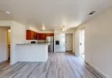 Located at 2020 Cheyenne Way in Modesto, California, this single-story, one-bedroom, two-bathroom residence offers a well-designed layout that maximizes its comfortable footprint. Light wood-style flooring runs throughout, creating a cohesive and clean aesthetic across all rooms.

The open-concept kitchen and living area serves as the heart of the home. The kitchen is equipped with warm-toned wood cabinetry, granite stone countertops, a peninsula breakfast bar, and a full suite of stainless steel appliances including a refrigerator, range, microwave, and dishwasher. The adjacent living room is bright and welcoming, featuring a stone-surround fireplace as a standout focal point, flanked by windows that invite natural light and outdoor views.

The bedroom is a well-proportioned retreat with a window offering natural light and access to a spacious walk-in closet outfitted with dual hanging rods and shelving. Two bathrooms, including one with granite countertops and white cabinetry, provide practical convenience. Sliding glass doors in multiple areas connect the interior to the outdoors, enhancing the sense of openness. Ceiling fans in the main living spaces add to the home's comfort and functionality.
