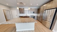 This contemporary 1290 square foot apartment offers a harmonious blend of style and functionality. The single-floor layout encompasses three bedrooms, including a generous 200 square foot primary bedroom, and two well-appointed bathrooms. The heart of the home is the open-concept kitchen and living area, showcasing a gourmet kitchen with sleek wooden cabinetry, stainless steel appliances, and a substantial granite-topped island. The kitchen's white subway tile backsplash and pendant lighting add a touch of elegance.

Throughout the apartment, light wood-look flooring creates a bright, airy atmosphere, complemented by large windows that flood the rooms with natural light. The bedrooms feature plush carpeting and ceiling fans for comfort. Both bathrooms boast modern fixtures, including glass-enclosed showers, granite countertops, and ample storage.

The neutral color palette, recessed lighting, and high ceilings contribute to the overall sense of spaciousness. Additional amenities include a pantry for extra storage and energy-efficient appliances. The property's location at 71 Boston Rd in Billerica, MA, offers convenient access to local amenities. This thoughtfully designed apartment combines contemporary aesthetics with practical living spaces, making it an ideal home for modern living.
