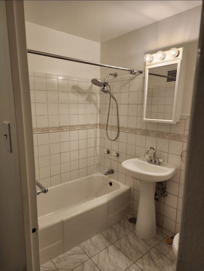 Brand new bathtub (photo is old). Will be a new light fixture and mirror cabinet - 6030 N Sheridan Rd