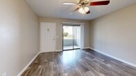 This 610 square foot apartment in Daytona Beach, Florida, offers a compact yet well-designed living space. The single-floor layout comprises one bedroom, one bathroom, and an open-concept living area. The kitchen is a standout feature, boasting modern stainless steel appliances, including a refrigerator, microwave, and oven. White cabinetry and a granite countertop with a breakfast bar add a touch of elegance.

The living room flows seamlessly from the kitchen, featuring wood-look flooring and access to a small outdoor area through sliding glass doors. The bedroom, measuring 130 square feet, includes a ceiling fan and a window for natural light. Carpeting in the bedroom adds comfort underfoot.

The bathroom is efficiently designed with a shower/tub combination, a single vanity, and wood-look flooring that matches the main living area. Two closets provide ample storage space throughout the apartment. Neutral wall colors and modern lighting fixtures create a bright, contemporary atmosphere. This apartment is an ideal choice for singles or couples seeking a cozy, low-maintenance living space in Daytona Beach.