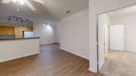 This 990 square foot apartment in Raleigh, NC offers a well-designed living space with two bedrooms and two bathrooms. The open-plan layout seamlessly integrates the kitchen, dining, and living areas, creating a spacious feel. The kitchen features light wood cabinetry, granite countertops, and white appliances, including a refrigerator and range. Track lighting adds a modern touch to the space.

The living area boasts hardwood flooring and crown molding, with large windows allowing natural light to flood the space. Both bedrooms are carpeted for comfort, with the primary bedroom measuring 160 square feet. Ceiling fans in the bedrooms provide additional air circulation.

The bathrooms feature granite countertops, wooden vanities, and combination shower/tub units. The apartment includes an in-unit laundry area with a washer and dryer, adding convenience for residents. Throughout the space, neutral wall colors create a blank canvas for personal decor.

The apartment's layout is efficient, with closet space in both bedrooms and a streamlined floor plan that maximizes the available square footage. Overall, this apartment offers a comfortable and modern living space in a desirable Raleigh location.