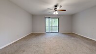 Located at 1535 Lascassas Pike in Murfreesboro, Tennessee, this single-floor, one-bedroom, one-bathroom unit offers a practical and comfortable layout across a well-utilized floor plan. Neutral gray walls and white trim carry throughout, creating a clean, cohesive aesthetic.

The living room is carpeted and filled with natural light from a large sliding glass door that opens to an outdoor view of lush surrounding trees. A ceiling fan with a light fixture adds both function and comfort to the space. Adjacent to the living room, the dining area features wood-look vinyl flooring and is highlighted by an elegant chandelier overhead.

The galley-style kitchen runs along two parallel walls, offering warm honey-toned cabinetry, generous upper and lower storage, wood-look vinyl flooring, and white appliances including a refrigerator, range, and dishwasher. A dedicated dining space connects seamlessly to the kitchen.

The spacious primary bedroom is carpeted and includes a louvered-door closet, additional storage access, and a window allowing natural light. The full bathroom is equipped with a tub/shower combo with a clean white surround and wood-look flooring. A dedicated laundry room with washer/dryer hookups and a built-in shelf completes this well-appointed unit.