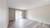 Located at 6592 Steinway Dr in Reynoldsburg, Ohio, this one-bedroom, one-bathroom residence offers a thoughtfully organized single-floor layout. Light-toned wood-look flooring runs throughout, complementing neutral warm-beige walls and textured ceilings to create a cohesive, clean aesthetic.

The combined living and dining area is the heart of the home, featuring a sliding glass door dressed with vertical blinds that fills the space with natural light and provides direct access to a private balcony with outdoor views. The open sightlines between the living and dining zones make the area feel spacious and versatile.

The kitchen is equipped with rich warm-toned wood cabinetry, ample upper and lower storage, a double-basin stainless steel sink, and a range with overhead ventilation — offering a functional and well-organized cooking space.

The bedroom is a comfortable, well-proportioned retreat featuring a window for natural light and generous closet storage, including two closets within the room itself. In total, the unit provides three closets, offering excellent organizational flexibility throughout.

The full bathroom is finished with a white vanity, a tub/shower combination, and the same wood-look flooring that ties the unit together. A utility room and hallway round out this efficiently designed and move-in ready residence.