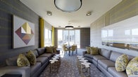 This sophisticated single-floor lounge is designed with a keen eye for contemporary style and functional comfort. The space is anchored by two large, charcoal-gray sectional sofas positioned symmetrically along either side of the room, creating an inviting and balanced layout ideal for social gatherings. Decorative floral-patterned throw pillows in gold and green add a vibrant pop of color, complementing the bold yellow drapes that frame the windows. Unique puzzle-shaped side tables in white and gold metallic finishes serve as eye-catching accent pieces throughout the seating area. A centrally placed dining set with neutral upholstered chairs provides a more intimate space for smaller group conversations or meetings. Overhead, a striking circular pendant light serves as a focal point, while recessed ceiling fixtures ensure even, ambient illumination throughout. The patterned carpet adds depth and texture to the floor, tying together the room's cohesive design palette of grays, golds, and greens. Large windows and a glass-paneled door flood the interior with natural light and offer views of an outdoor terrace and surrounding scenery, enhancing the open, airy ambiance of the space.