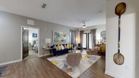 Located at 2439 Casona Ln in Melbourne, Florida, this thoughtfully designed single-floor residence offers a cohesive blend of modern finishes and comfortable living spaces. The expansive living room serves as the heart of the home, showcasing wood-style flooring, a ceiling fan, and French doors that invite natural light. A separate dining area features wood-style flooring and neutral gray walls, providing an elegant setting for entertaining. The galley-style kitchen is well-appointed with stainless steel appliances, dark wood cabinetry, granite countertops, a deep single-basin sink, and pendant lighting. Each bedroom is carpeted and generously sized, offering walk-in closets with wire shelving systems for organized storage. The bathrooms are finished with granite-topped vanities, wood-style tile flooring, and tub-shower combinations. A dedicated laundry room houses a full-size Whirlpool washer and dryer alongside overhead wire shelving. Throughout the residence, neutral gray walls provide a versatile backdrop, while consistent wood-style flooring in the main areas ties the spaces together. The overall ambiance is bright, modern, and move-in ready.