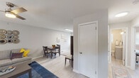 Located at 700 Hampstead Pl in Raleigh, NC, this single-floor home offers a thoughtfully designed layout with a clean, modern aesthetic carried throughout each room. Light wood-look flooring runs continuously across the living spaces, enhancing the sense of openness and cohesion.

The living room is a welcoming, well-proportioned space featuring a ceiling fan, a large window with blinds that invites natural light, and neutral walls that provide a versatile backdrop. The dining area flows naturally from the living space and is accentuated by a trio of botanical-print wall art, adding a refined decorative touch.

The kitchen is a standout feature of the home, outfitted with white shaker-style cabinetry, subway tile backsplash, light stone-look countertops, and stainless steel appliances including a refrigerator and range. A window above the sink allows natural light to brighten the workspace.

The bedrooms are comfortably sized, each equipped with ceiling fans and windows that allow for ample natural light. The rooms offer a calm, restful atmosphere with neutral wall tones and light flooring. The bathroom includes a full tub-shower combination with built-in shelving and brushed nickel fixtures. An additional flexible room with two windows and a ceiling fan is well-suited as a bedroom, office, or sitting room.