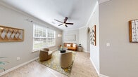 This thoughtfully designed one-bedroom, one-bathroom unit at 2002 Battlecreek Dr offers a comfortable and efficient single-floor layout. The spacious living area is highlighted by crown molding, a ceiling fan, and large windows fitted with plantation-style blinds that allow ample natural light to fill the room. Light wood-style flooring runs throughout the main living spaces, adding warmth and continuity.

The galley-style kitchen is well-equipped with stainless steel appliances, including a refrigerator, electric range, and built-in microwave. White shaker cabinetry with brushed nickel hardware and granite-style countertops provide generous storage and prep space. An adjacent dining area with a modern chandelier connects seamlessly to the kitchen.

The bedroom features plush carpeting, a ceiling fan, sliding glass door access to the patio, and a walk-in closet offering ample storage. The full bathroom includes a white vanity with granite-style countertops, a large mirror, and a tub/shower combination.

Additional highlights include in-unit laundry, two closets for extra storage, and a private patio for outdoor enjoyment. The unit's neutral color palette and clean finishes create a bright, cohesive ambiance throughout.