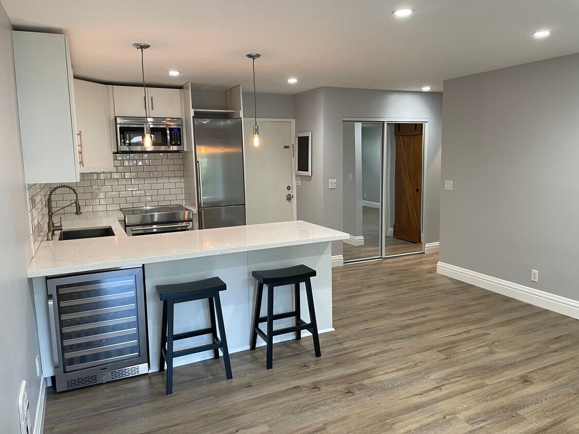 Kitchen with wine fridge and counter seating area - 1817 California St