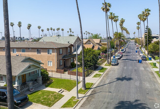 Single story craftsman home sits next to large apartments in Canndu/Avalon Gardens.
