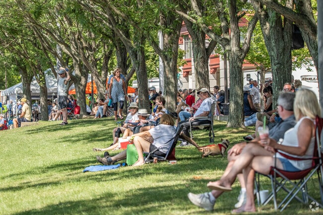 People sat in the shade on a hot day to watch the Wheeling Regatta.