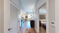 Located at 159 1st Avenue North in Franklin, TN, this one-bedroom, one-bathroom residence offers a thoughtfully designed single-floor layout with modern finishes and an efficient use of space. Hardwood-style flooring flows throughout, tying each area together seamlessly.

The combined kitchen and living area forms the heart of the home. The kitchen features white shaker cabinetry, granite countertops, a subway tile backsplash, stainless steel appliances, and recessed lighting. Adjacent to the kitchen, the living area is bathed in natural light from large windows that frame views of the surrounding Franklin streetscape, including glimpses of neighboring brick architecture and lush greenery.

The bedroom offers a cozy retreat with a ceiling fan, a built-in closet with shelving and hanging storage, and soft neutral tones. The full bathroom is finished with large-format tile flooring, a tub/shower combination, and a vanity with ample storage.

A hallway with louvered closet doors connects the main living spaces, while a dedicated entry area provides a welcoming transition into the home. The overall ambiance is light, clean, and contemporary, reflecting the charm of its downtown Franklin location.