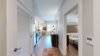 Located at 159 1st Avenue North in Franklin, TN, this one-bedroom, one-bathroom residence offers a thoughtfully designed single-floor layout with modern finishes and an efficient use of space. Hardwood-style flooring flows throughout, tying each area together seamlessly.

The combined kitchen and living area forms the heart of the home. The kitchen features white shaker cabinetry, granite countertops, a subway tile backsplash, stainless steel appliances, and recessed lighting. Adjacent to the kitchen, the living area is bathed in natural light from large windows that frame views of the surrounding Franklin streetscape, including glimpses of neighboring brick architecture and lush greenery.

The bedroom offers a cozy retreat with a ceiling fan, a built-in closet with shelving and hanging storage, and soft neutral tones. The full bathroom is finished with large-format tile flooring, a tub/shower combination, and a vanity with ample storage.

A hallway with louvered closet doors connects the main living spaces, while a dedicated entry area provides a welcoming transition into the home. The overall ambiance is light, clean, and contemporary, reflecting the charm of its downtown Franklin location.