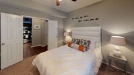 Located at 2752 Gaston Ave in Dallas, Texas, this single-floor residence offers a thoughtfully designed layout with modern finishes and a cohesive contemporary aesthetic. The living area is anchored by large windows that invite natural light, complemented by crown molding, rich hardwood-style flooring, and ceiling fans that add both function and style. A generously sized sectional sofa and bold abstract wall art give the space a vibrant, curated character.

The kitchen features dark espresso cabinetry, granite-style countertops, and stainless steel appliances, including a full-size refrigerator and range, all arranged in an efficient galley-style configuration with ample storage.

The bedrooms are well-proportioned and carpeted for comfort. One bedroom showcases a striking burnt-orange accent wall paired with ceiling fans and large windows that provide outdoor views and natural light. Both bedrooms offer a calm, restful atmosphere with generous closet access.

The bathrooms are finished with dark cabinetry, granite-style countertops, hardwood-style flooring, and full tub-shower combinations with stylish curtains. One bathroom includes an extended vanity with a large mirror and additional storage overhead.

Overall, the space presents a modern, energetic interior palette with consistent warm tones, quality finishes, and functional design throughout.