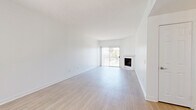 Located at 11005 Morrison St in North Hollywood, this 2-bedroom, 2-bathroom unit offers a well-designed layout with light wood-style flooring running throughout. The open living room is bright and airy, featuring a classic fireplace with a tiled surround and a sliding glass door that fills the space with natural light and provides access to a balcony with outdoor views. A ceiling fan adds comfort to the generous living area.

The galley-style kitchen is thoughtfully appointed with white shaker cabinetry, quartz countertops, a subway tile backsplash, and a full suite of stainless steel appliances, including a gas range, built-in microwave, dishwasher, and refrigerator. A window above the sink brings in additional natural light.

The primary bedroom offers a comfortable footprint, a sliding glass door to the balcony, and a closet with mirrored sliding doors. The second bedroom also features a sliding glass door and access to a dedicated closet. Both bathrooms are finished in white with wood-style flooring, white vanities with brushed nickel hardware, and large mirrors. One bathroom includes a soaking tub with shower, while the second features a walk-in shower stall.