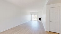 Located at 11005 Morrison St in North Hollywood, this 2-bedroom, 2-bathroom unit offers a well-designed layout with light wood-style flooring running throughout. The open living room is bright and airy, featuring a classic fireplace with a tiled surround and a sliding glass door that fills the space with natural light and provides access to a balcony with outdoor views. A ceiling fan adds comfort to the generous living area.

The galley-style kitchen is thoughtfully appointed with white shaker cabinetry, quartz countertops, a subway tile backsplash, and a full suite of stainless steel appliances, including a gas range, built-in microwave, dishwasher, and refrigerator. A window above the sink brings in additional natural light.

The primary bedroom offers a comfortable footprint, a sliding glass door to the balcony, and a closet with mirrored sliding doors. The second bedroom also features a sliding glass door and access to a dedicated closet. Both bathrooms are finished in white with wood-style flooring, white vanities with brushed nickel hardware, and large mirrors. One bathroom includes a soaking tub with shower, while the second features a walk-in shower stall.