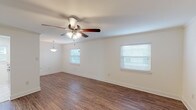 This single-floor residence features 2 bedrooms and 2 bathrooms within a thoughtfully arranged floor plan. The main living area is bright and welcoming, finished with durable hardwood-style flooring and crisp white walls that create a clean, airy atmosphere. Multiple windows fitted with blinds allow natural light to filter throughout, while ceiling fans with integrated lighting provide both comfort and illumination. A pendant light fixture adds a decorative touch to the dining area adjacent to the living space.

The kitchen is well-appointed with white shaker-style cabinetry, granite-look countertops, a stainless steel double-basin sink, and a built-in dishwasher. A window above the counter brings in additional natural light, making the space feel open and functional.

Both bedrooms are carpeted for warmth and comfort, each equipped with a ceiling fan and window. The bedrooms offer closet storage, including a bifold-door closet with built-in shelving and hanging rods. The bathrooms are finished with marble-style tile flooring and tub surrounds, white vanities with drawers, and chrome fixtures, presenting a clean and updated aesthetic throughout. The overall design is neutral and move-in ready.