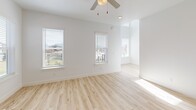 Located in Herriman, Utah, this well-appointed 4-bedroom, 4-bathroom home is spread across three thoughtfully designed floors. The exterior features a clean modern facade with lap siding, a single-car garage, a concrete driveway, and freshly landscaped mulched beds with views of the surrounding Wasatch mountain range.

The main floor hosts an open-concept kitchen and living area finished with light hardwood-style flooring. The kitchen stands out with two-tone cabinetry — white uppers paired with navy lowers — a large central island with a white countertop and pendant lighting, subway tile backsplash, and stainless steel appliances including a gas range and French door refrigerator.

Upstairs, the upper floor contains the bedrooms, including a generously sized primary suite with multiple windows that invite natural light, a ceiling fan, and an en suite bathroom with dark cabinetry and a walk-in closet complete with built-in shelving. Additional bedrooms feature vaulted ceilings, plush carpet, and ample natural light. A dedicated laundry area with a full-size washer and dryer adds everyday convenience.

The basement level offers two unfinished spaces with insulated walls and a utility room, providing excellent potential for customization. A staircase connects all three levels seamlessly throughout this move-in-ready home.