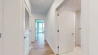 Located at 55 Riverside Dr in Yonkers, NY, this thoughtfully designed three-bedroom, two-bathroom residence offers an impressive blend of modern finishes and sweeping Hudson River views. Light-toned hardwood flooring flows throughout, complementing the clean white walls and creating a bright, cohesive aesthetic across the entire floor plan.

The open-concept kitchen and living area serves as the heart of the home, featuring sleek dual-tone cabinetry — white uppers paired with navy-blue lowers — topped with light stone countertops. A floor-to-ceiling window frames dramatic waterfront views, allowing natural light to flood the space. The living area extends to a private balcony enclosed by glass railings, offering unobstructed panoramic views of the Hudson River and the surrounding landscape.

Each of the three bedrooms is generously proportioned, with large floor-to-ceiling windows that invite abundant natural light and showcase the river and cityscape beyond. Seven closets throughout the residence, including walk-in options, provide exceptional storage.

The two bathrooms are finished with striking marble-style tile on both floors and walls, complemented by a stylish gray vanity with stone countertops and a frameless mirror. A dedicated laundry area and multiple hallways add to the functional layout of this well-appointed Riverside Drive residence.