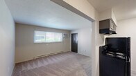 Located at 540 W Alexis Rd in Toledo, Ohio, this single-floor, 2-bedroom, 1-bathroom unit offers a practical and straightforward layout designed for comfortable everyday living. The kitchen is equipped with dark cabinetry, a black electric range, a refrigerator, and a single-basin sink, all set atop light wood-look vinyl flooring that adds a clean, modern touch. A baseboard heater along the kitchen wall ensures consistent warmth throughout the cooler months. Both bedrooms feature neutral-toned carpeting, beige walls, and baseboard heating. The primary bedroom includes a wide window that allows natural light to fill the space, while the second bedroom benefits from ample sunlight and features a full-width bi-fold closet for generous storage. An additional bedroom also includes a bi-fold closet, maximizing storage options. The bathroom is well-appointed with a full tub-shower combo, a toilet, a wood-toned vanity with a countertop sink, tile accents, and light wood-look flooring that coordinates with the kitchen. A textured ceiling and overhead ventilation complete the bathroom. Overall, the unit maintains a clean, neutral aesthetic with consistent finishes, practical amenities, and a functional floor plan suited for a variety of living arrangements.