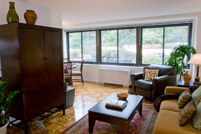 Living and dining areas with parquet flooring - eaves Glover Park Apartments