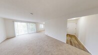 Located at 935 Aintree Park Dr in Mayfield, OH, this single-floor residence offers four bedrooms, two bathrooms, and a well-organized layout designed for comfortable everyday living. The open living and dining area is bright and airy, featuring neutral-toned carpeting, crisp white walls, and large windows with vertical blinds that fill the space with natural light. A sliding glass door provides access to an outdoor area, further enhancing the sense of openness. The galley-style kitchen is thoughtfully appointed with white shaker cabinetry, dark countertops, wood-look flooring, and a full suite of stainless steel appliances, including a range, over-the-range microwave, and refrigerator. A window at the end of the kitchen adds additional natural light. The four bedrooms are generously proportioned, each featuring soft carpeting and ample natural light from individual windows. The spacious primary bedroom stands out for its considerable size and versatility. Both bathrooms are finished consistently with white cabinetry, dark countertops, a single basin sink, wood-look flooring, and brushed nickel fixtures. The layout is further complemented by two hallways and two closets, providing practical storage solutions throughout the home.