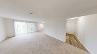 Located at 935 Aintree Park Dr in Mayfield, OH, this single-floor residence offers four bedrooms, two bathrooms, and a well-organized layout designed for comfortable everyday living. The open living and dining area is bright and airy, featuring neutral-toned carpeting, crisp white walls, and large windows with vertical blinds that fill the space with natural light. A sliding glass door provides access to an outdoor area, further enhancing the sense of openness. The galley-style kitchen is thoughtfully appointed with white shaker cabinetry, dark countertops, wood-look flooring, and a full suite of stainless steel appliances, including a range, over-the-range microwave, and refrigerator. A window at the end of the kitchen adds additional natural light. The four bedrooms are generously proportioned, each featuring soft carpeting and ample natural light from individual windows. The spacious primary bedroom stands out for its considerable size and versatility. Both bathrooms are finished consistently with white cabinetry, dark countertops, a single basin sink, wood-look flooring, and brushed nickel fixtures. The layout is further complemented by two hallways and two closets, providing practical storage solutions throughout the home.