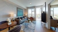 Located in the vibrant North Park neighborhood of San Diego, this single-floor residence at 4499 Ohio St offers a thoughtfully designed layout with contemporary finishes throughout. The living room is a welcoming focal point, featuring light wood flooring, a subtly textured accent wall, and large floor-to-ceiling windows with sheer drapery that flood the space with natural light. A sliding glass door opens onto a private balcony, offering open views of the surrounding cityscape and palm trees. The kitchen is outfitted with light wood cabinetry, white subway tile backsplash, quartz countertops, stainless steel appliances, and a central island with pendant lighting — ideal for both cooking and casual dining. The primary bedroom is a serene retreat with a textured feature wall, large windows framing neighborhood views, warm wood flooring, and ample space for furnishings. A second bedroom continues the refined aesthetic with similar finishes and generous natural light. The bathroom features a wide dual-sink vanity with light wood cabinetry, quartz countertops, and a full soaking tub with shower combination. Clean lines, a neutral palette, and cohesive modern design elements tie each room together, creating a comfortable and polished living environment throughout.