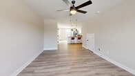 Located at 1003 Lafayette Rd in Clarksville, TN, this two-story home offers 2 bedrooms, 3 bathrooms, and two closets thoughtfully distributed across both floors. The exterior presents a attractive combination of brick and board-and-batten siding in a cool slate blue, with dedicated parking directly in front.

The main floor features an open-concept living and dining area with light-toned luxury vinyl plank flooring and a ceiling fan. The modern kitchen is well-appointed with white shaker cabinetry, dark countertops, stainless steel appliances, a peninsula with bar seating, and stylish pendant lighting. A half bathroom on this floor adds convenience for guests. Natural light filters in through multiple windows fitted with horizontal blinds.

Upstairs, both bedrooms are carpeted and include ceiling fans, with the spacious primary bedroom offering a dedicated closet and private access to a full bathroom. The second bedroom is equally comfortable with a large window framing outdoor views. Bathrooms are finished cleanly in white, featuring tub-shower combinations with matte black fixtures. A second full bathroom serves the upper level. The staircase features wood-toned treads with a clean white riser design, connecting both levels with a polished, cohesive aesthetic throughout.
