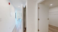 Located in Vancouver's vibrant Mount Pleasant neighbourhood, this modern 1-bedroom, 3-bathroom unit at 2511 Carolina Street offers a thoughtfully designed interior with clean, contemporary finishes throughout. Light-toned laminate wood flooring flows through every room, complementing the crisp white walls and creating a bright, cohesive aesthetic.

The open-concept kitchen and living area serves as the heart of the unit, featuring flat-panel white cabinetry, quartz countertops, a marble-style tile backsplash, and a stainless steel sink beneath a black-framed window. The kitchen's efficient L-shaped layout maximizes functionality without sacrificing style.

The bedroom is a calm, minimal retreat with a floor-to-ceiling black-framed window that invites natural light and offers neighbourhood views. A dedicated walk-in closet with wire shelving provides practical storage. Three well-appointed bathrooms include a full bath with a soaker tub, white subway-style tile surround, an undermount sink vanity, and a mirrored medicine cabinet.

A standout feature is the generous balcony, enclosed by sleek glass railings, which delivers sweeping panoramic views of the Vancouver skyline, North Shore mountains, and surrounding neighbourhood — an ideal setting for outdoor relaxation.