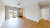 Located at 100 Township Blvd in Lebanon, TN, this well-appointed one-bedroom, two-bathroom home offers a thoughtfully designed single-level layout. The open-concept living and dining area features warm hardwood-style flooring, neutral toned walls, recessed lighting, and a ceiling fan, with a sliding glass door that opens to a private balcony overlooking a pool and green surroundings, filling the space with natural light.

The kitchen is a standout feature, showcasing white shaker cabinetry, quartz countertops, a subway tile backsplash, stainless steel appliances, and a large island with a undermount sink and pendant lighting — ideal for both cooking and casual dining.

The spacious bedroom is finished with plush carpeting, a ceiling fan, and multiple windows with blinds that provide ample natural light and outdoor views. The en-suite bathroom offers a double-sink vanity with white cabinetry and hardwood-style flooring, complemented by a soaking tub with tiled surround and built-in corner shelving. A generously sized walk-in closet with wire shelving provides excellent storage.

A dedicated laundry room houses a full-size washer and dryer with overhead wire shelving, adding everyday convenience to this well-rounded home.