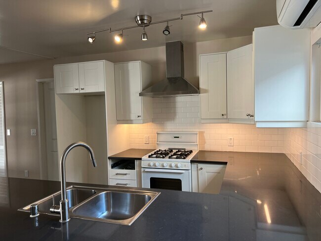 Beautiful contemporary kitchen with easy clean and attractive stone counters - 467 S Bentley Ave