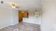 Located at 5011 S Alston Ave in Durham, NC, this single-floor, 2-bedroom, 3-bathroom unit offers a practical and well-organized layout. The kitchen serves as a central hub, featuring warm oak cabinetry, light countertops, stainless steel appliances including a dishwasher, refrigerator, and gas range, and a peninsula that provides additional prep space while opening toward the living area. Wood-look plank flooring runs throughout the main living and kitchen spaces, while a sliding glass door in the living area brings in natural light and provides access to an outdoor space. A textured ceiling is consistent throughout the unit. Both bedrooms are carpeted and offer a quiet, comfortable feel, with windows that allow natural light and outdoor views. The primary bedroom includes a dedicated closet and connects to an en-suite bathroom, providing added privacy. A hallway closet with wire shelving adds convenient storage. The bathrooms are functional and clean in design, with one featuring a full tub-shower combination with chrome fixtures and wood-look tile flooring. Overall, the unit presents a cohesive, neutral palette with efficient use of space throughout.