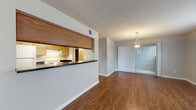 Located at 8000 Oakdell Way in San Antonio, Texas, this single-floor unit offers a practical and well-organized layout designed for comfortable everyday living. Rich wood-style flooring runs consistently throughout the space, lending warmth and visual continuity to every room.

The living area is open and inviting, filled with natural light from large windows dressed with horizontal blinds. It flows seamlessly into the dining area, which is accented by a stylish pendant light fixture and a sliding glass door with vertical blinds that opens to the outdoors. A pass-through counter with a dark countertop connects the living and dining spaces to the kitchen, creating an open and sociable feel.

The galley-style kitchen is efficiently arranged, featuring warm wood cabinetry, dark countertops, a double stainless steel sink, a white electric range, a refrigerator, and a dishwasher, all complemented by under-cabinet ventilation and ample storage.

The bedrooms are comfortably sized, each equipped with a ceiling fan and light kit, windows that admit natural light, and the same wood-style flooring found throughout. The bathroom includes a wood-toned vanity with a dark countertop and single basin sink, a lighted mirror, and a full tub-and-shower combination with white tile surround.