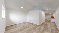 This 620 square foot apartment, located at 1200 S Meridian Ave in Oklahoma City, OK, offers a thoughtfully designed living space on a single floor. The property features one bedroom measuring 120 square feet, complemented by one full bathroom. The interior showcases modern finishes throughout, with a neutral color palette dominated by crisp white walls that create a bright, airy atmosphere.

The apartment boasts wood-look flooring throughout, adding warmth and durability to the space. The kitchen is a highlight, featuring white shaker-style cabinets, light-colored countertops, and stainless steel appliances, including a gas range and refrigerator. Under-cabinet lighting enhances the functional workspace.

The living area is open and versatile, with ample room for both lounging and dining. Windows with horizontal blinds allow natural light to flood the space, while a wall-mounted air conditioning unit provides climate control. The bedroom, though compact, offers enough space for essential furnishings and includes a window for natural light and ventilation.

The bathroom is fully tiled in white, featuring a bathtub-shower combination with a curved shower rod and necessary accessories. Two closets provide additional storage options. The apartment's efficient layout maximizes the use of space, making it an ideal choice for those seeking a modern, low-maintenance living environment in Oklahoma City.
