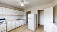 Located at 720 Melany Ln in Colorado Springs, Colorado, this single-floor home offers a straightforward and functional layout suited for comfortable everyday living. The kitchen is equipped with white cabinetry providing ample storage, a double-basin sink, a dishwasher, and a full-size refrigerator. Tile flooring runs throughout the kitchen, adding durability to a high-traffic area, while a ceiling fan overhead keeps the space well-ventilated. A dedicated storage closet with built-in shelving is conveniently accessible directly from the kitchen. The living areas and bedrooms feature wall-to-wall carpet, lending a warm and quiet atmosphere to each room. Multiple rooms are fitted with ceiling fans and windows dressed with blinds, allowing natural light to filter in while maintaining privacy. The bedroom spaces offer views of the surrounding neighborhood through their windows. The bathroom includes a full tub and shower combo surrounded by white tile walls, along with a standard toilet. The overall layout, as seen in the dollhouse view, is compact yet efficient, with clear separation between the kitchen, living, and sleeping areas, making this a practical and livable Colorado Springs home.