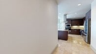 This sleek 1330 sq ft apartment in San Diego offers a harmonious blend of style and functionality. The open-concept layout seamlessly integrates the living room and kitchen, creating an ideal space for both relaxation and entertainment. The gourmet kitchen boasts rich wood cabinetry, stainless steel appliances, and a striking tile backsplash, complemented by a center island with a granite countertop.

Floor-to-ceiling windows flood the space with natural light and provide stunning cityscape views. The primary bedroom, spanning 220 sq ft, offers ample space and includes an en-suite bathroom featuring a double vanity with marble countertops and a glass-enclosed shower. The second bedroom and bathroom maintain the same high standard of design.

Hardwood floors run throughout the main living areas, while the bathrooms and kitchen feature elegant tile flooring. The apartment includes a spacious walk-in closet with built-in organizers. Modern amenities such as recessed lighting, a ceiling fan, and roller shades add both comfort and style to this urban retreat.