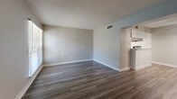 Located at 2600 Highland Rd in Dallas, TX, this single-floor, 2-bedroom, 2-bathroom home offers a practical and well-organized layout across a comfortable footprint. The dual living areas feature rich wood-look flooring and neutral gray walls, creating a clean, versatile backdrop. Large windows with horizontal blinds allow natural light to fill the space, enhancing its open, airy feel. A textured ceiling and ceiling fans are present throughout, adding functional character.

The two kitchens are outfitted with white cabinetry, granite-style countertops, stainless steel sinks, and black appliances including a gas range, refrigerator, and dishwasher. Light wood-look flooring ties the kitchen areas together with a bright, modern aesthetic.

Both bedrooms are carpeted for comfort. The spacious primary bedroom features dual closets and a ceiling fan with light fixture, while the second bedroom also includes a ceiling fan and ample room. The hallway connects the private areas of the home seamlessly.

Each of the two bathrooms includes a full tub-shower combination with a tiled surround, brushed nickel fixtures, and white vanity with stone-look countertops. The overall design is clean, neutral, and move-in ready, well-suited for everyday living in a convenient Dallas location.