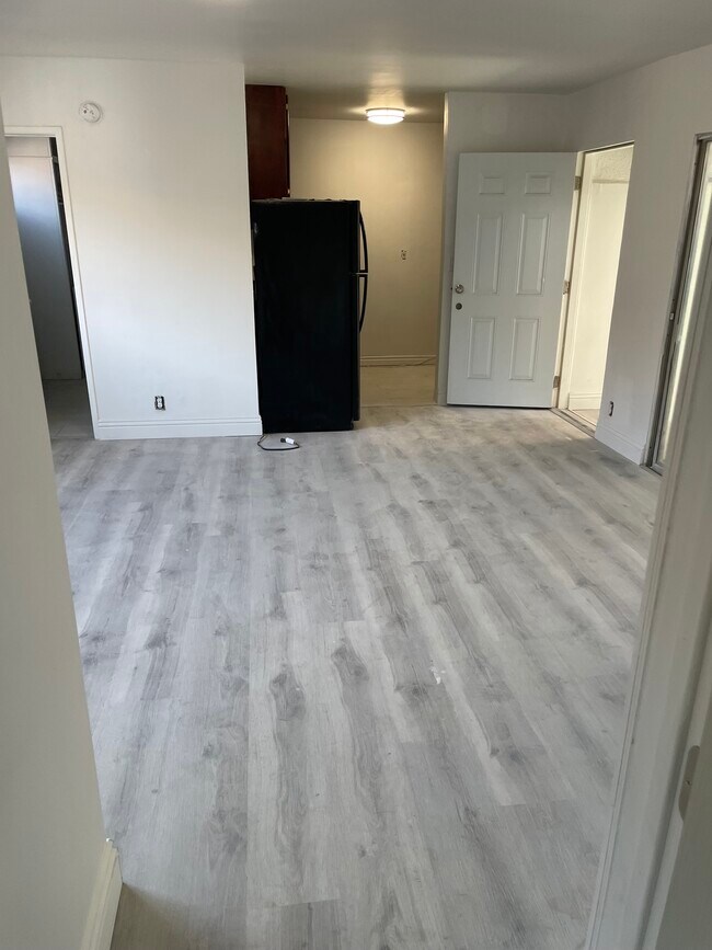living room leading to kitchen - 5447 Blackwelder St Apartments