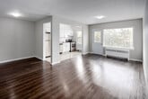 Located at 186 Thames St in Chatham-Kent, Ontario, this 2-bedroom, 1-bathroom unit offers a clean, modern aesthetic across a thoughtfully designed single-floor layout. The open living area is anchored by warm hardwood-style flooring and neutral grey-toned walls, creating a bright and versatile space ideal for both relaxing and entertaining. A hallway connects the living area to the rest of the unit, providing a logical and efficient flow throughout.

The kitchen is well-equipped with white shaker-style cabinetry, a classic subway tile backsplash, stainless steel appliances including a refrigerator, stove, and dishwasher, and light tile flooring. A window above the stove brings in natural light and offers a view of the surrounding greenery.

Both bedrooms continue the hardwood-style flooring and neutral palette. The primary bedroom offers generous proportions with a built-in sliding door closet, while the second bedroom also features closet storage and easy access to the hallway. The bathroom is finished with white subway tile surrounding a full bathtub, maintaining the clean and consistent design found throughout the unit. Overall, the space presents a fresh, move-in-ready interior with practical features and a cohesive modern style.