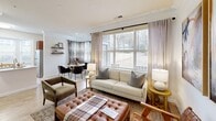 Located in Raleigh, NC, this thoughtfully designed 2-bedroom, 3-bathroom single-floor residence offers a comfortable and cohesive living experience. The living room serves as the heart of the home, featuring light hardwood-style flooring, large windows that invite abundant natural light, and a classic white fireplace with crown molding detail — a standout architectural feature that adds warmth and character to the space. An adjacent dining area flows naturally from the living room, enhancing the open feel.

The kitchen is well-equipped with rich warm-toned cabinetry, light granite countertops, a subway tile backsplash, and stainless steel appliances including a range, over-the-range microwave, and refrigerator. A bay window nook adds extra brightness and charm.

The primary bedroom offers a serene retreat with soft carpet, sage green accent walls, natural light from a curtained window, and an en-suite bathroom. The second bedroom is equally comfortable, featuring neutral tones, plush carpet, a double-door closet, and convenient bathroom access. A light-toned hallway with panel doors and wood-look tile connects the private spaces.

The bathrooms are clean and functional, with one featuring a tiled tub-shower combo with a decorative checkered tile border. Two dedicated closets provide practical storage throughout.
