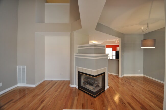 Double-sided gas fireplace joins the living and dining rooms in this open floor plan - 6478 Silver Mesa Drive Unit C