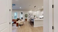 Located on W Vickery Blvd in Fort Worth, TX, this well-appointed 2-bedroom, 2-bathroom residence offers a thoughtfully designed single-floor layout. The open-concept living and kitchen area serves as the heart of the home, featuring light wood-look flooring, recessed lighting, and a seamless flow between spaces. The kitchen stands out with white upper cabinetry, bold navy blue lower cabinets on the island, a herringbone tile backsplash, stainless steel appliances, and a breakfast bar ideal for casual dining. The living room is bright and inviting, with built-in shelving, large windows that draw in natural light, and access to an outdoor area. The primary bedroom offers generous proportions, large windows with outdoor views, a dedicated closet with built-in shelving and gold-tone hardware, and a well-designed en-suite bathroom featuring a soaking tub, white tile surround, extended vanity with white countertops, and black fixture accents. The second bedroom and bathroom mirror the same clean, modern aesthetic. Both bathrooms include illuminated mirrors, white cabinetry with gold hardware, and wood-look flooring. Every detail reflects a contemporary design sensibility with a warm, cohesive palette throughout.