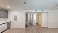 Located in Baton Rouge, Louisiana, this single-story 2-bedroom, 2-bathroom home offers a clean, modern design with a thoughtfully organized layout. Light wood-look flooring runs consistently throughout the space, complementing the crisp white walls and creating a bright, cohesive aesthetic.

The bedrooms are well-proportioned, each featuring a ceiling fan with integrated lighting, a window fitted with blinds for natural light and privacy, and easy access to the hallway. The spacious primary bedroom includes an open closet with a full-width hanging rod, providing practical storage. The second bedroom mirrors the same clean, functional design.

Both bathrooms are finished in a contemporary style, each equipped with a tub-shower combination featuring brushed nickel fixtures, a single-sink vanity with a white countertop and modern cabinetry, and light wood-look flooring that ties the space together seamlessly.

The hallway connects all rooms efficiently and includes a visible electrical panel, multiple HVAC vents ensuring consistent climate control throughout, and recessed lighting in select areas. The overall layout, visible in the dollhouse view, reflects an efficient single-floor floor plan with well-defined rooms and clear circulation paths. This home presents a clean, updated interior ready for immediate occupancy.